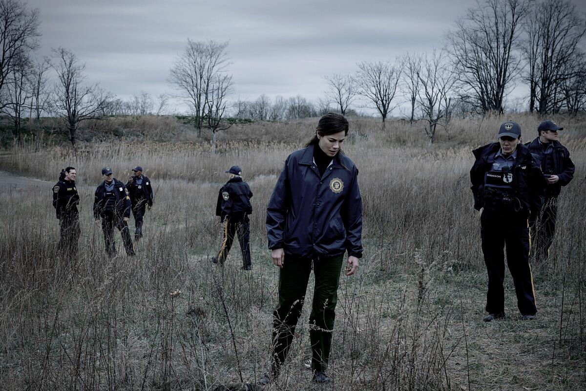 Michelle Monaghan wanders in a field in "The Whisper Man." 