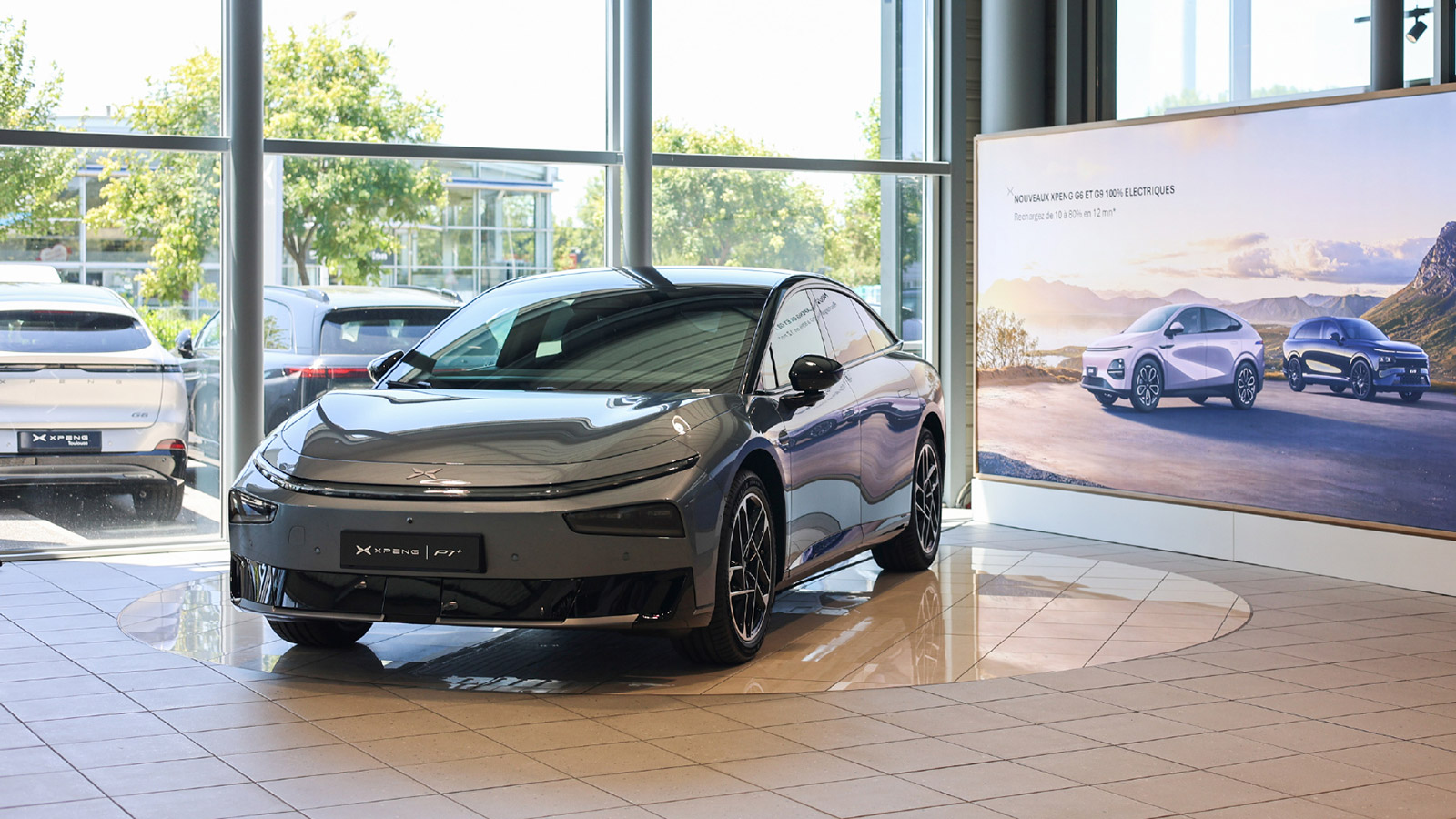 Xpeng P7+ milestone vehicle displayed at an Xpeng showroom in France.