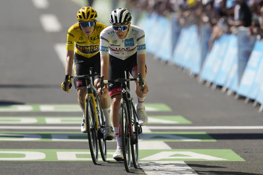 <p>Danish rider Jonas Vingegaard, in the yellow jersey, tries to break away from Slovenian rider Tadej Pogacar, in the white jersey, during the Tour de France, Saturday, July 16, 2022. </p>
