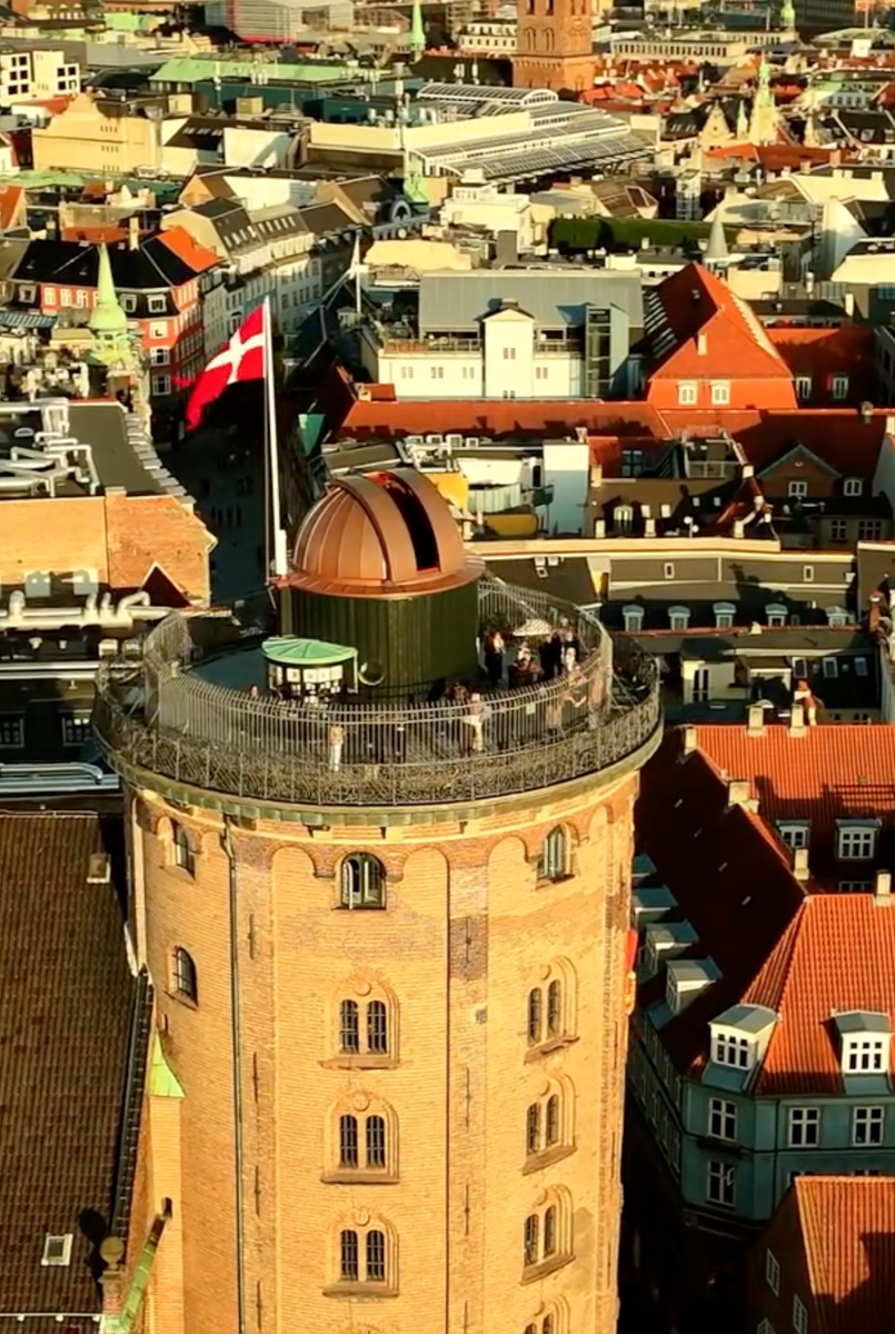 The Danish King took in the rare solar eclipse from one of Copenhagen’s most iconic landmarks.