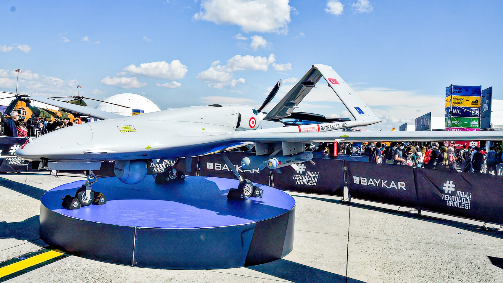 Bayraktar TB2 armed drone on a display stand at Teknofest with a crowd behind it