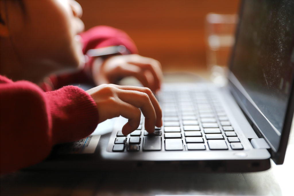 Why the tween years are a good time to talk to your kids about AI A young girl is playing at a computer