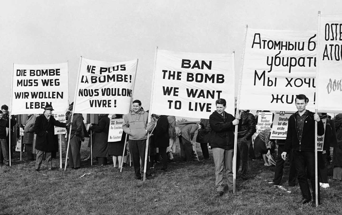 Demonstrators displaying signs in German, French, English, and Russian near a future rocket range in Bavaria, Germany, 1961.