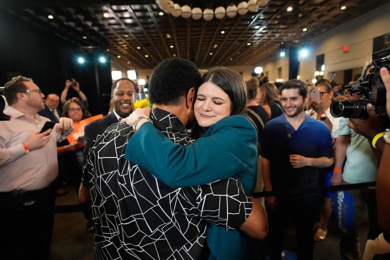 Rep. Haley Stevens hugs an attendee during her primary election night event in Detroit, on Wednesday.
