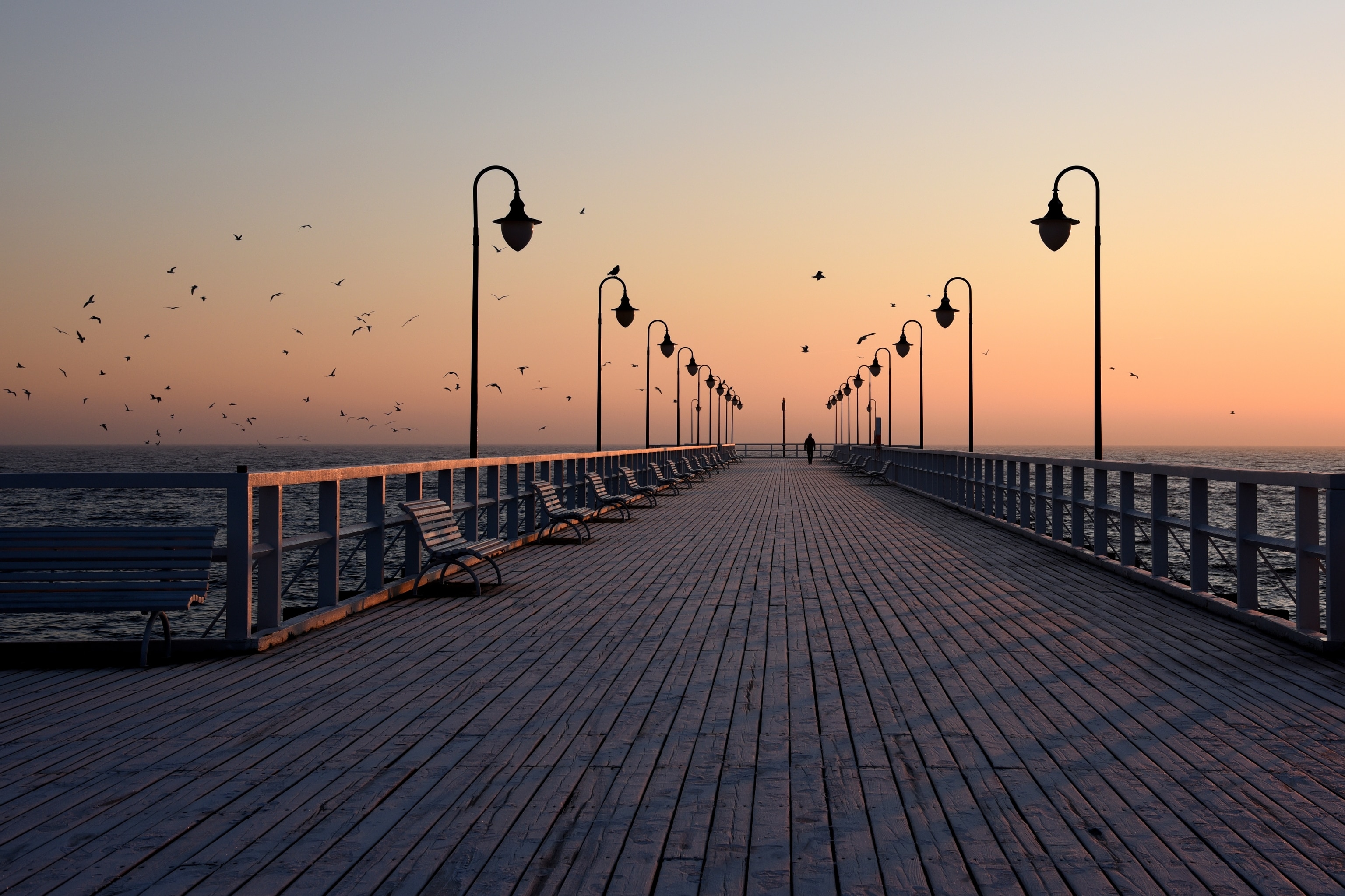 Sunset view of long wooden pier