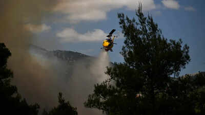 A video showed aircraft crossing paths at low altitude before one crashed in flames Watch: Firefighting helicopters collide mid-air as Greece battles massive wildfire