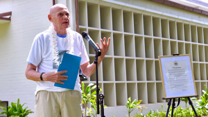 person speaking at a microphone