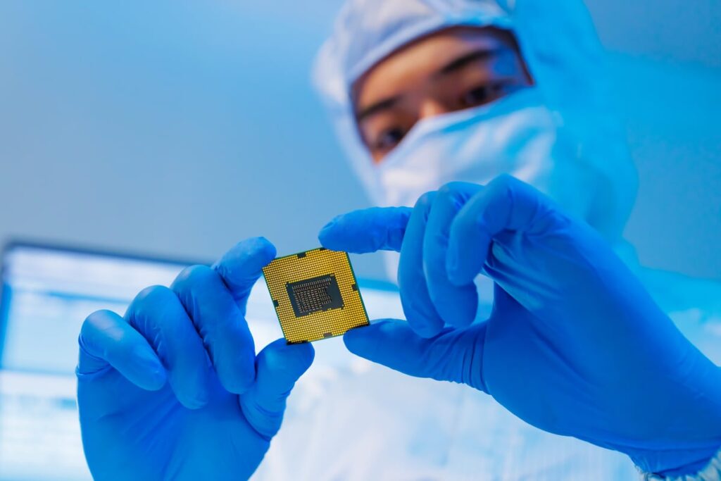 Not Nvidia. Not AMD. This Semiconductor Giant Will Be the Ultimate Winner of the Artificial Intelligence (AI) Hardware Race. An inspector looking at a chip.