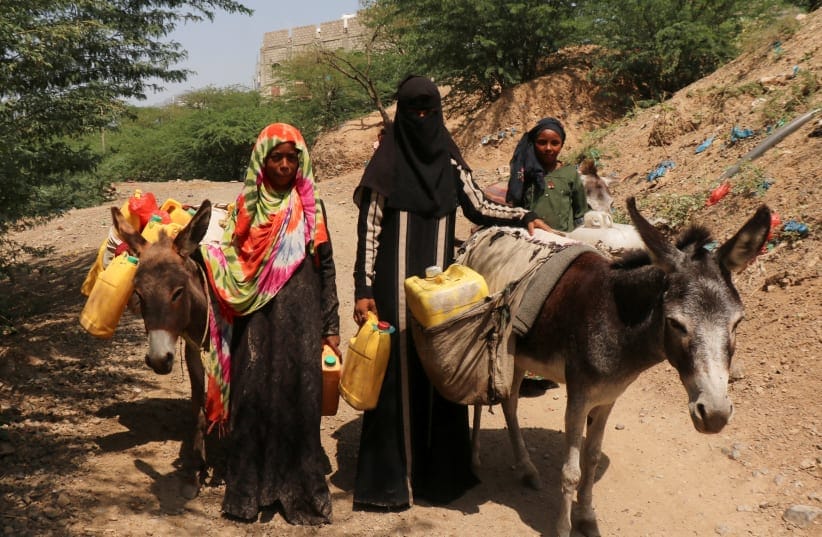 Women use donkeys to transport water jerrycans to the al-Bireen camp for displaced people who fled fighting between the Houthis and forces of Yemen's internationally recognized government in Taiz province, Yemen, September 17, 2026.