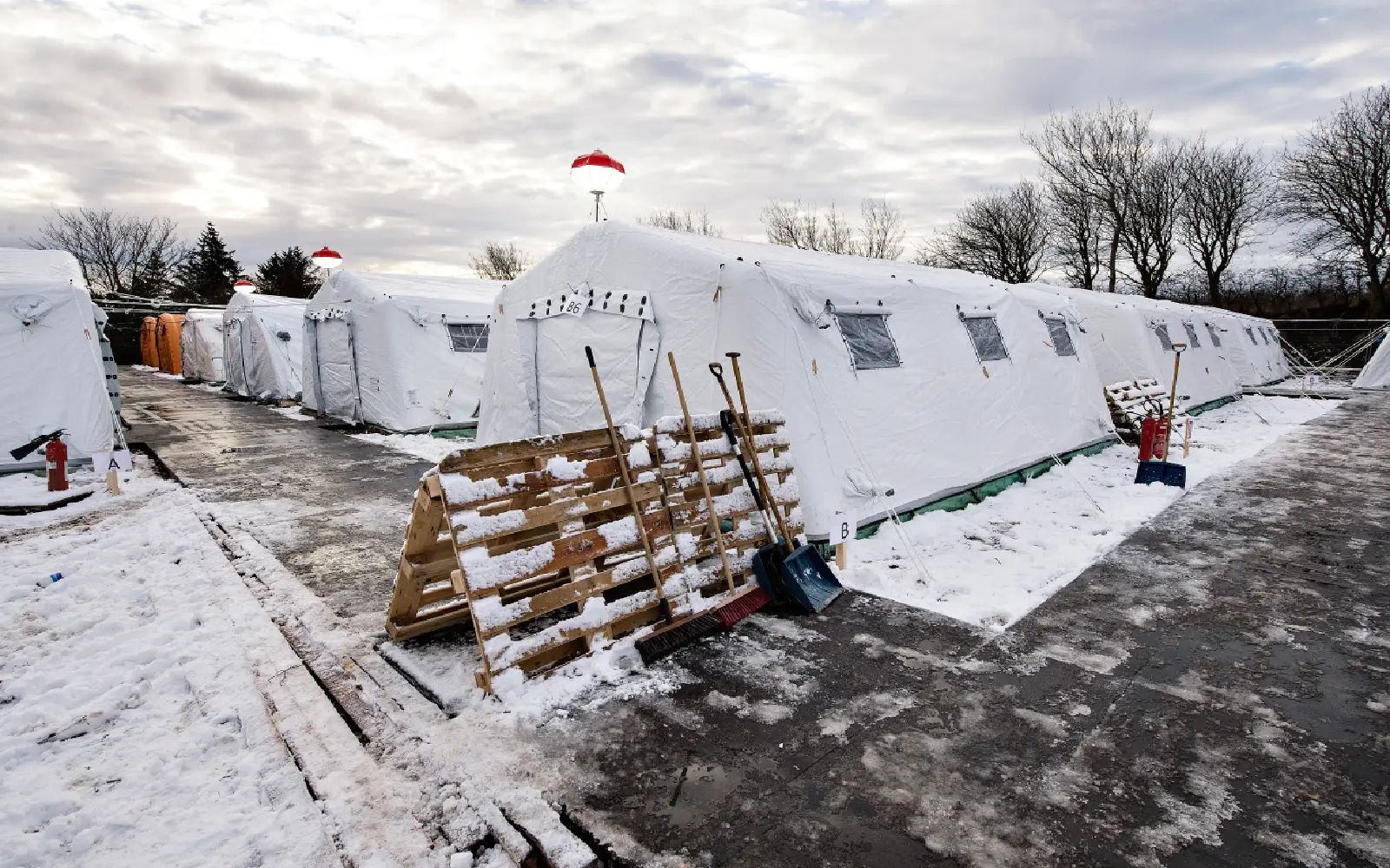 epa05126733 (FILE) A file photo dated 23 November 2015 showing a general view of the refugee tent camp in Thisted, northern Jutland, Denmark. The camp contains small appartment areas in the gym, bunkbeds and tents. Danish lawmakers were 26 January 2016 set to vote on measures to tighten asylum laws, including a controversial plan to seize assets from asylum seekers to pay for their stay, despite criticism from human rights groups. The bill was expected to pass as the right-leaning Liberals' minority government has secured backing from others, including the main opposition Social Democrats and the anti-immigrant Danish People's Party. The move would allow for asylum seekers' belongings to be searched and for cash or valuables exceeding 10,000 kroner (1,450 dollars) to be seized. The cash and proceeds from the sale of the valuables - such as watches and mobile phones - would be used to pay for the asylum seekers' stay in Denmark. EPA/HENNING BAGGER DENMARK OUT
