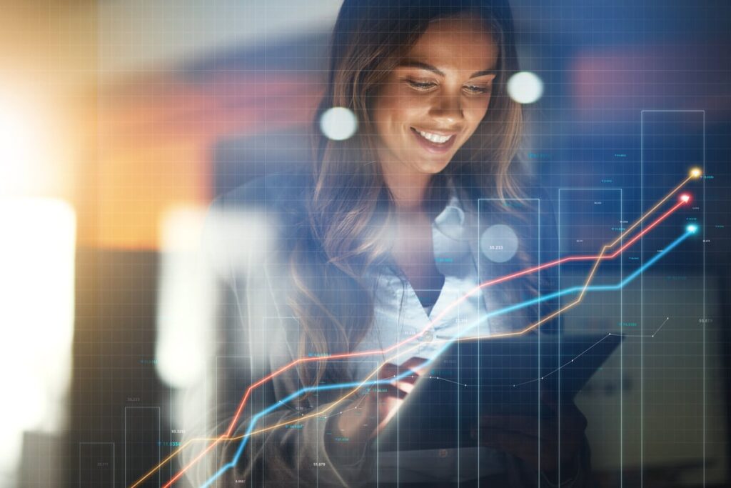 Got $5,000? 3 No-Brainer Artificial Intelligence (AI) Stocks to Buy Right Now. Rising stock chart projected on a virtual screen in front of a smiling investor working on a tablet.