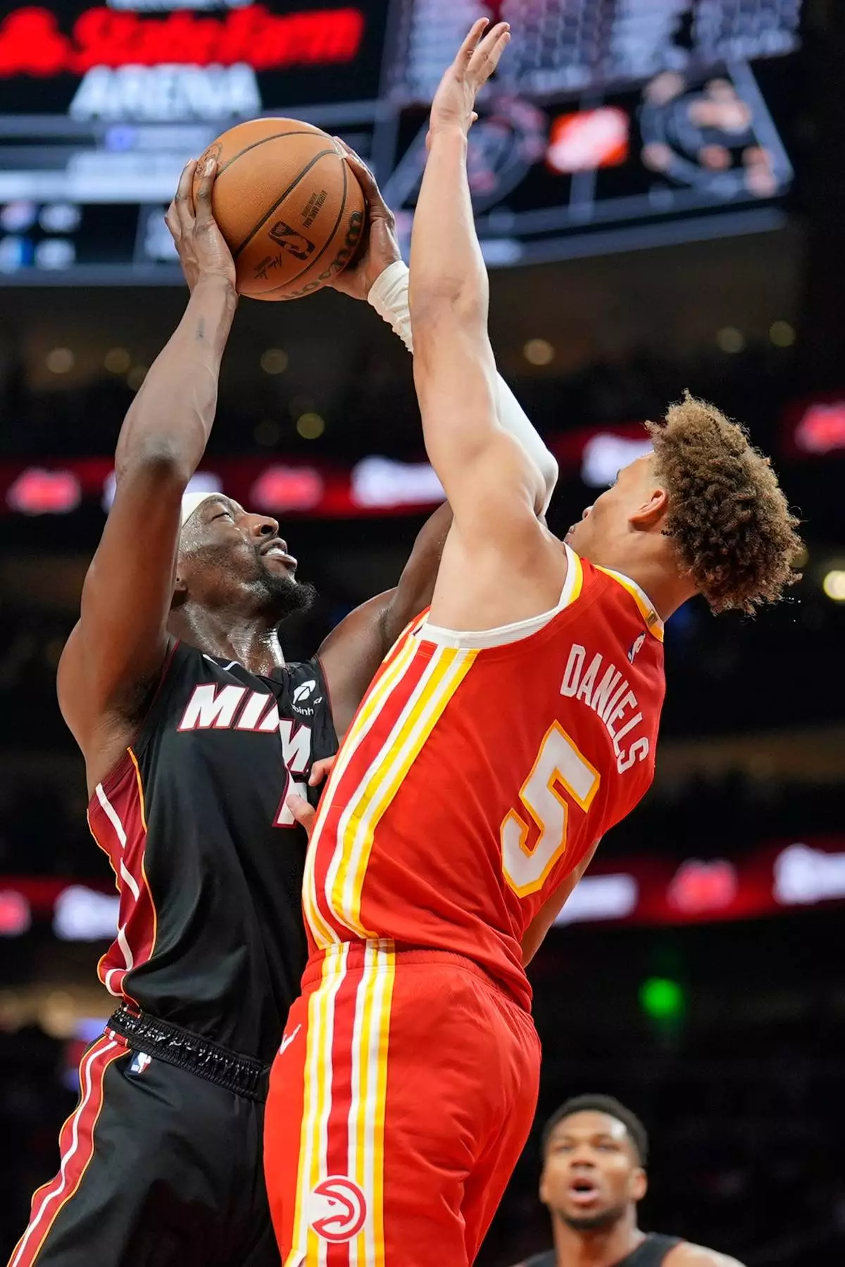 Miami Heat center Bam Adebayo (13) shoots against Atlanta Hawks guard Dyson Daniels (5) during the second half of an NBA basketball game, Wednesday, Oct. 28, 2026, in Atlanta. (AP Photo/Mike Stewart)