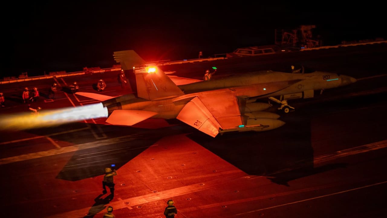 An F/A-18 Super Hornet prepares to launch from the flight deck of USS George Washington (CVN 73) as the aircraft carrier sails regional waters in the Middle East.