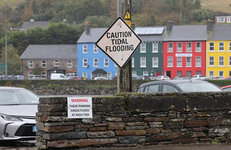 Signage warning of potential flood risk along the quayside in Bantry, Co Cork. Photograph: Alan Betson/The Irish Times
