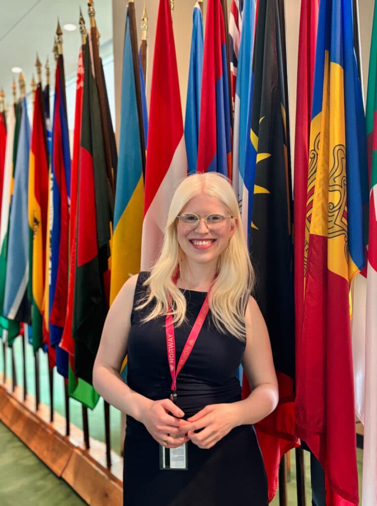 A woman standing in front of flags