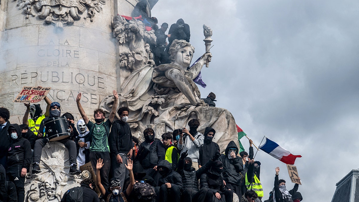 Demonstrators occupy the sculptures and ledges of the Monument a la Republique in Paris, France, on October 17, 2026.