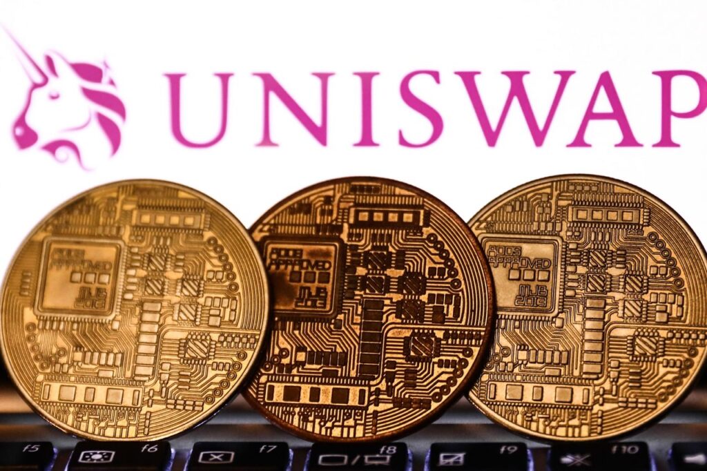 Uniswap logo displayed on a phone screen and representation of cryptocurrency are seen in this illustration photo taken in Krakow, Poland on November 6, 2021. (Photo by Jakub Porzycki/NurPhoto via Getty Images)